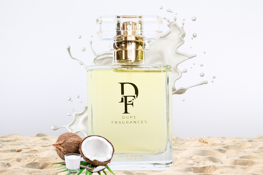 50ml Dupe Fragrances perfume Beach Crush inspired by Cheirosa 87 by Sol De Janiero.  Clear bottle on beach sand with coconut milk splash in the background